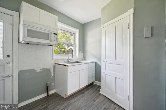 kitchen featuring white cabinets, sink, and dark hardwood / wood-style floors