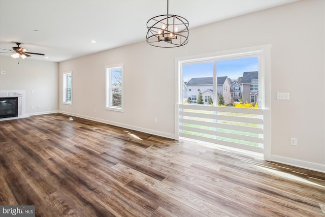 unfurnished living room featuring baseboards and wood finished floors