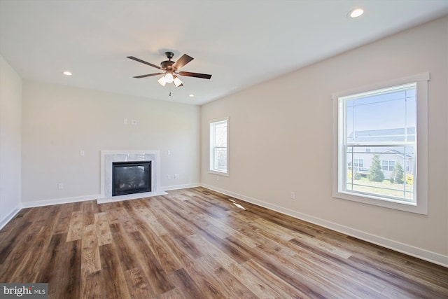 unfurnished living room featuring wood finished floors, a ceiling fan, and recessed lighting