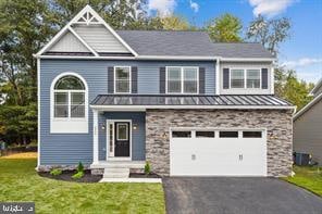 view of front of home featuring a front lawn and a garage