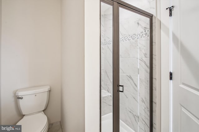 full bath with a marble finish shower and toilet