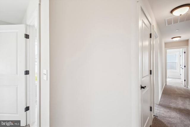 hall with visible vents and carpet