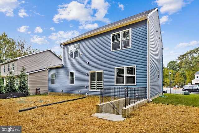 back of property with a lawn
