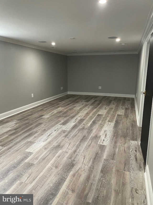 unfurnished room featuring crown molding and hardwood / wood-style flooring