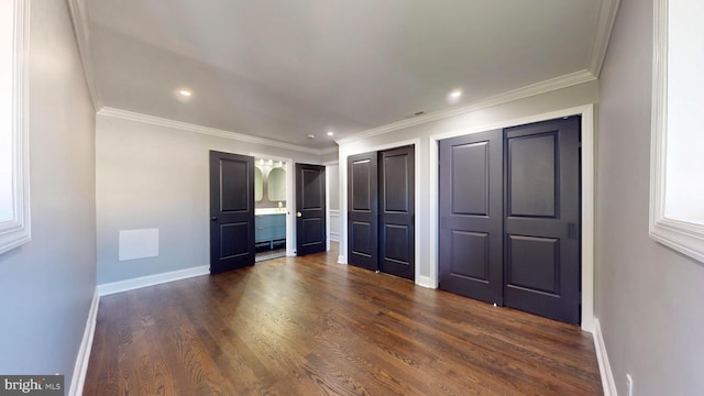 unfurnished bedroom with ornamental molding and dark hardwood / wood-style flooring