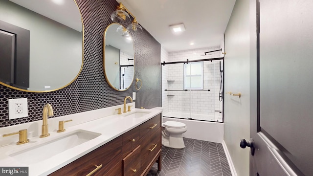 full bathroom featuring vanity, tile patterned flooring, toilet, shower / bath combination with glass door, and backsplash