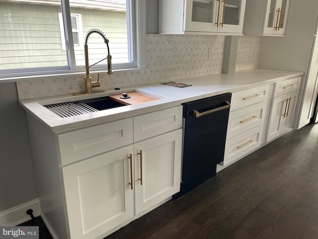 kitchen featuring white cabinets, sink, tasteful backsplash, dark wood-type flooring, and black dishwasher