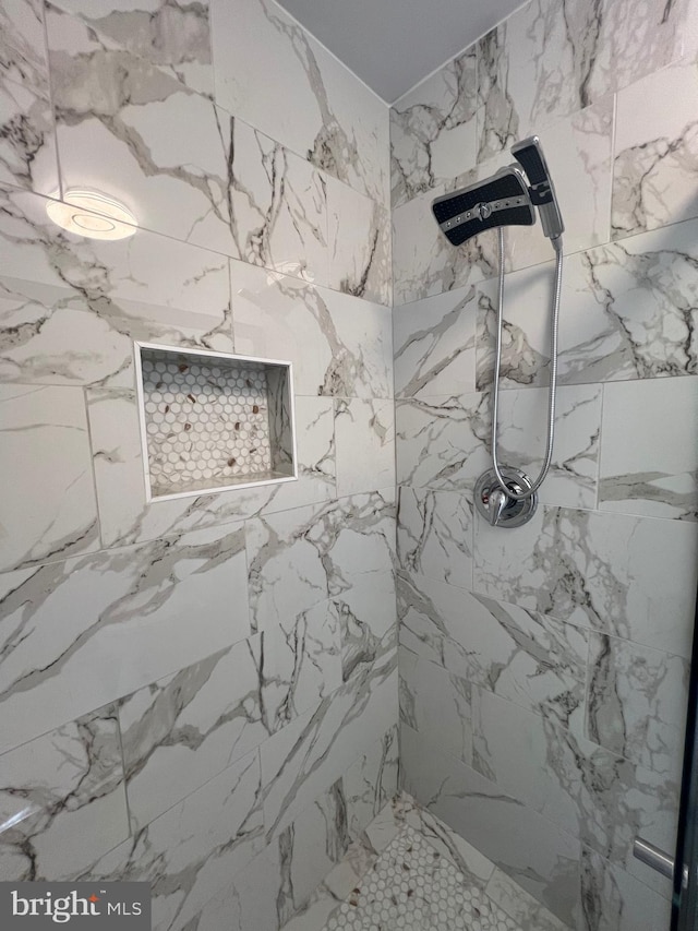 bathroom with a tile shower