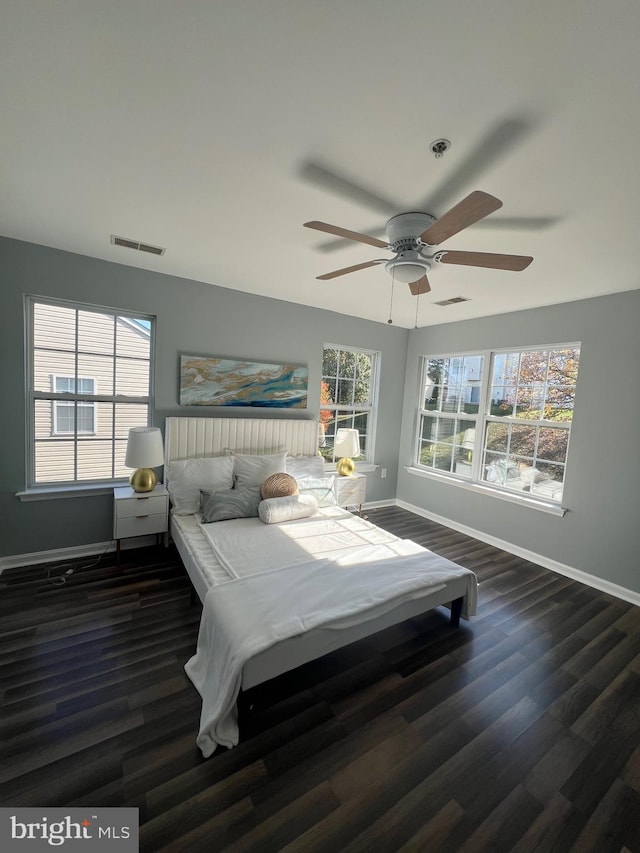 bedroom with ceiling fan and dark hardwood / wood-style flooring