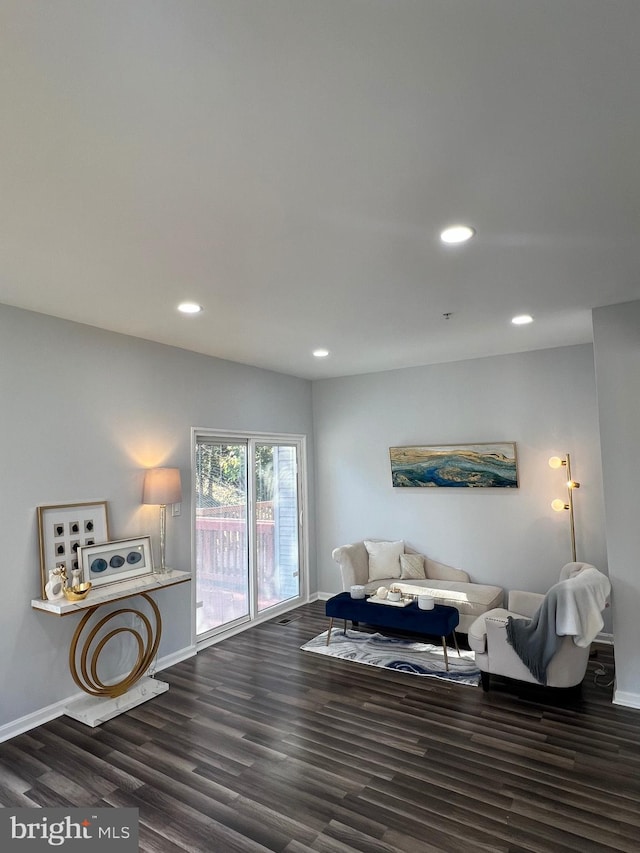 living room with dark hardwood / wood-style flooring