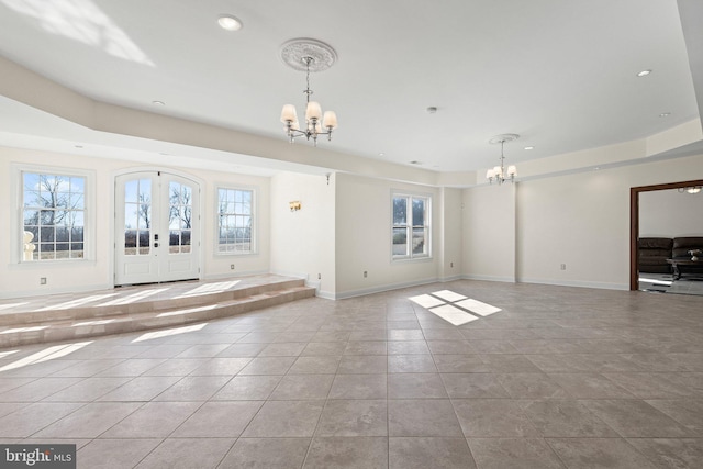 foyer featuring light tile patterned floors, french doors, baseboards, and a notable chandelier