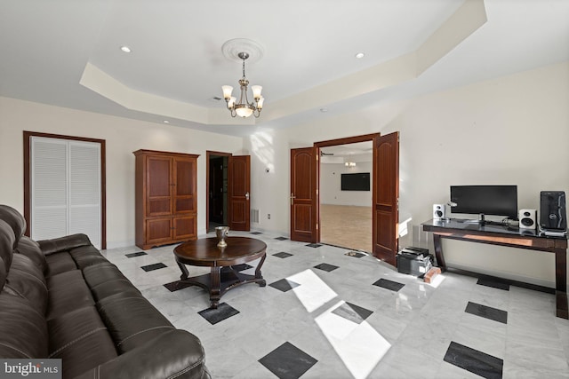 living area featuring baseboards, a tray ceiling, a chandelier, and recessed lighting