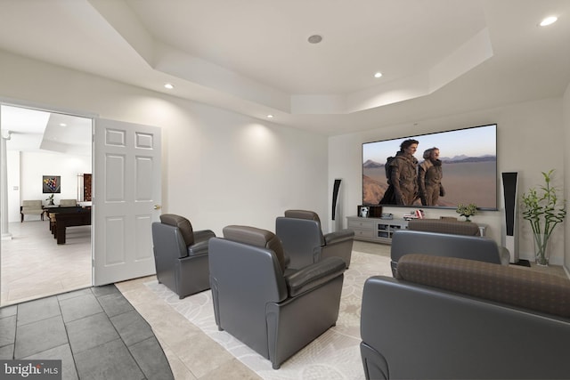 cinema featuring a tray ceiling, light tile patterned flooring, and recessed lighting