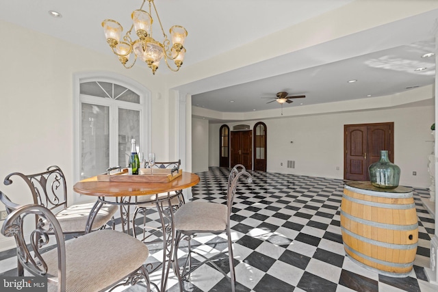 dining room featuring arched walkways, recessed lighting, a raised ceiling, tile patterned floors, and ceiling fan with notable chandelier