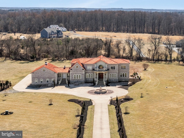 birds eye view of property with a forest view and a rural view