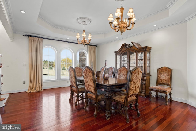 dining space with baseboards, dark wood-style flooring, a raised ceiling, and a notable chandelier