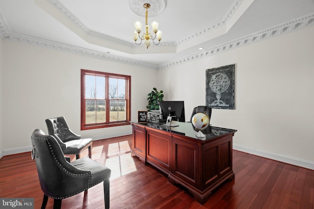 office space with baseboards, a tray ceiling, dark wood finished floors, and a notable chandelier