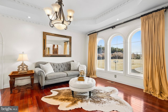 sitting room with a chandelier, visible vents, hardwood / wood-style flooring, and baseboards