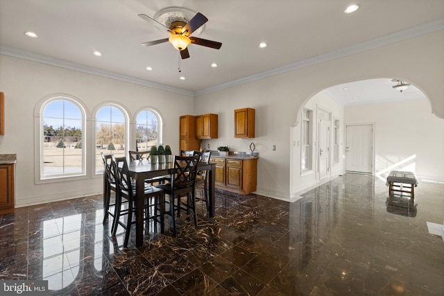 dining room featuring arched walkways, marble finish floor, recessed lighting, and baseboards