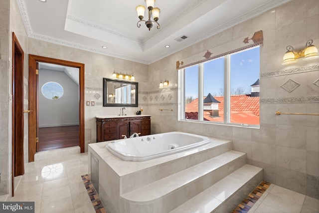 bathroom featuring a tray ceiling, visible vents, vanity, tile patterned flooring, and a whirlpool tub