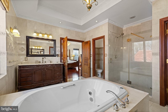 bathroom featuring a stall shower, toilet, ornamental molding, a whirlpool tub, and tile walls