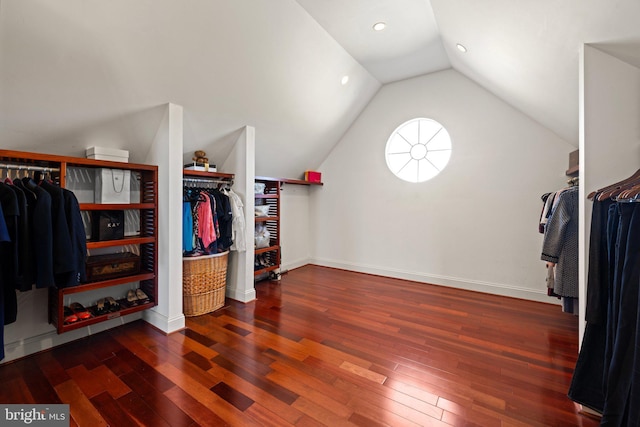 spacious closet featuring lofted ceiling and hardwood / wood-style flooring