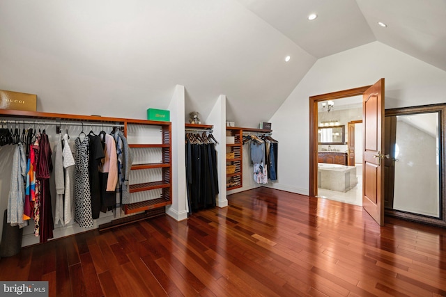 spacious closet featuring lofted ceiling and wood finished floors