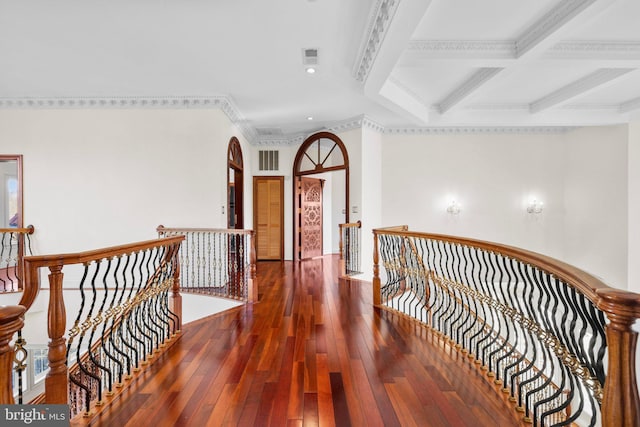 hall featuring hardwood / wood-style flooring, coffered ceiling, an upstairs landing, beam ceiling, and crown molding