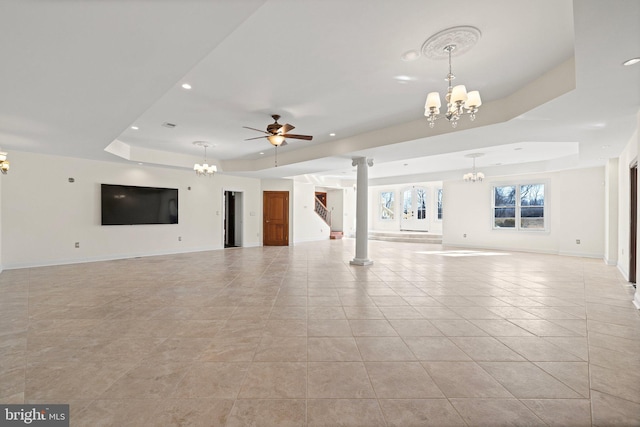 unfurnished living room featuring light tile patterned floors, recessed lighting, ceiling fan with notable chandelier, baseboards, and a tray ceiling