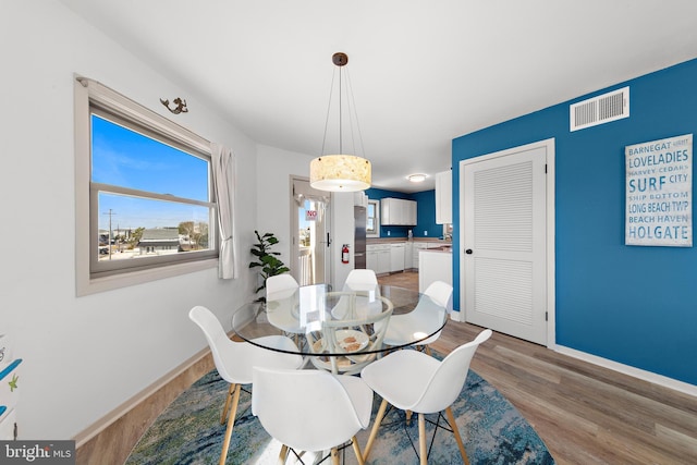 dining room with light hardwood / wood-style flooring