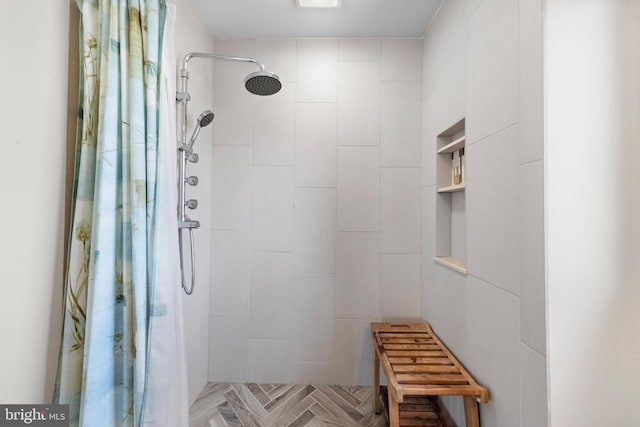 bathroom featuring parquet floors and a shower with curtain