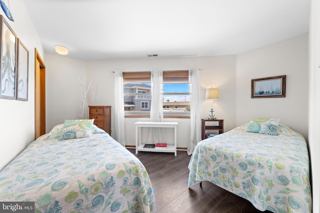 bedroom with dark hardwood / wood-style floors