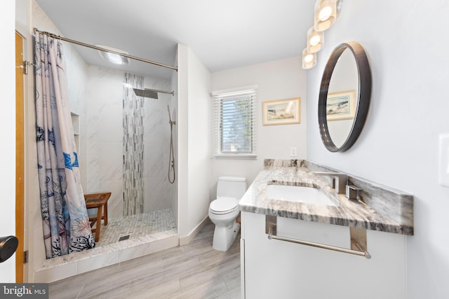 bathroom with toilet, walk in shower, vanity, and wood-type flooring