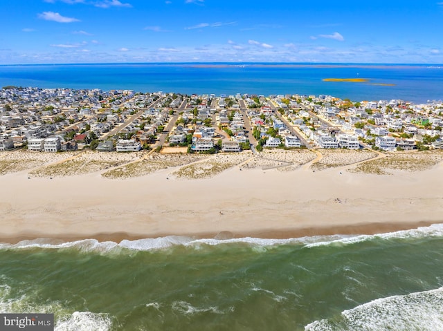 bird's eye view featuring a water view and a view of the beach