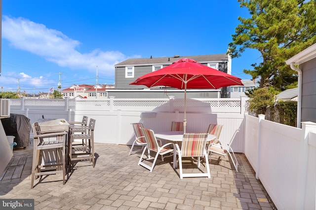 15 Weldon Pl, Long Beach Township, NJ 08008 - view of patio with area for grilling, a fenced backyard, and outdoor dining area