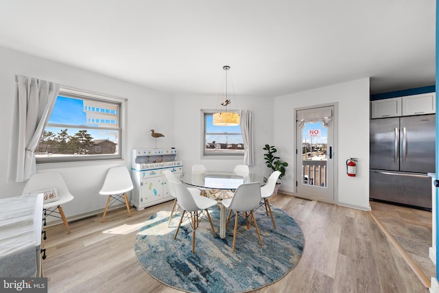 dining area featuring light hardwood / wood-style floors and a wealth of natural light