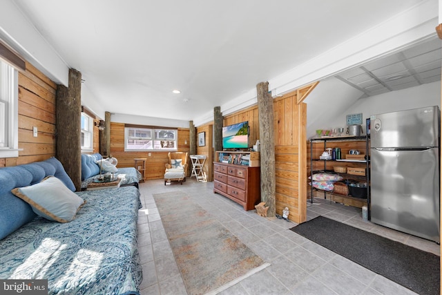 living room with light tile patterned floors and wooden walls