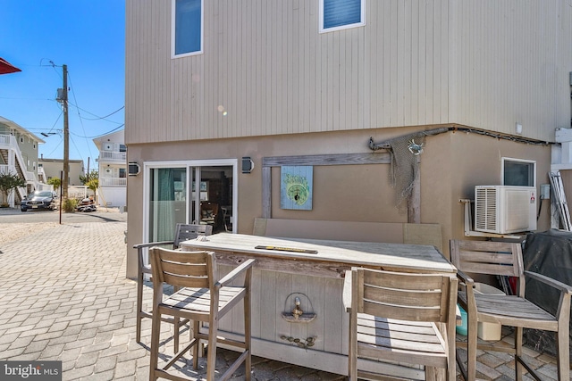 15 Weldon Pl, Long Beach Township, NJ 08008 - rear view of house with stucco siding, outdoor dry bar, and a patio