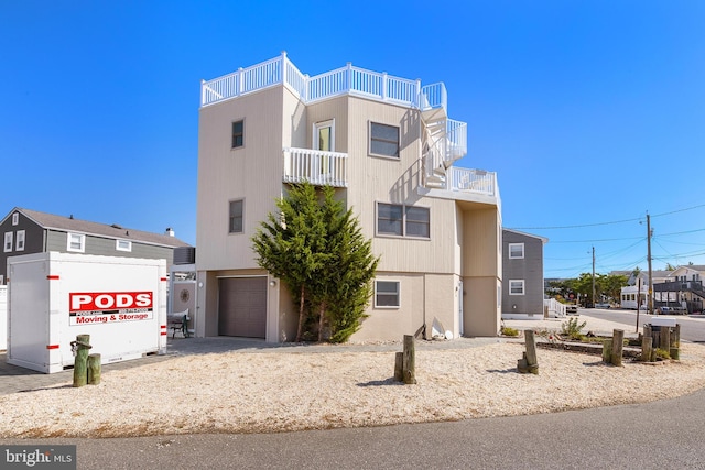 view of front of house featuring a balcony and a garage