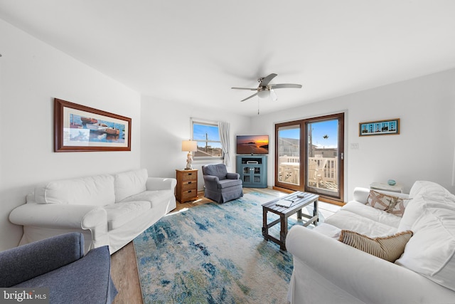 living room with hardwood / wood-style floors and ceiling fan