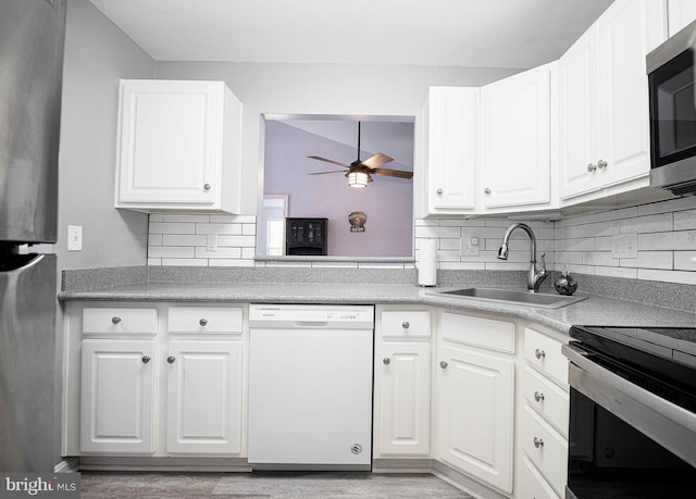 kitchen with dishwasher, backsplash, sink, and white cabinetry