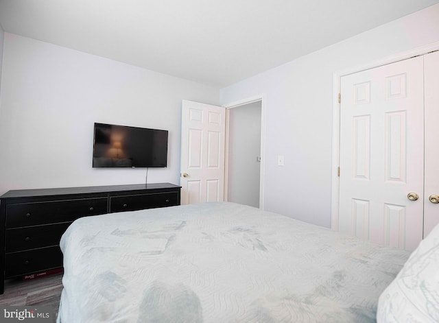 bedroom featuring a closet and dark hardwood / wood-style flooring