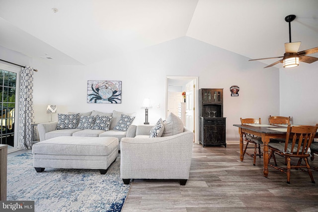 living room with lofted ceiling, wood-type flooring, and ceiling fan