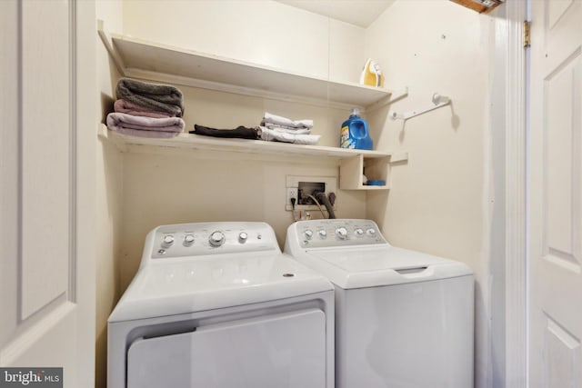 clothes washing area featuring washer and dryer