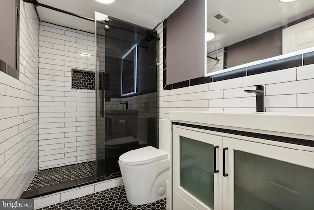 bathroom featuring walk in shower, tile walls, toilet, vanity, and tile patterned flooring