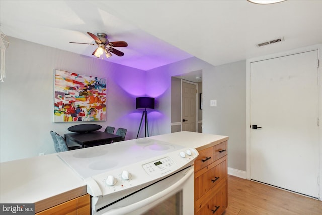 kitchen with ceiling fan, white electric stove, and light wood-type flooring