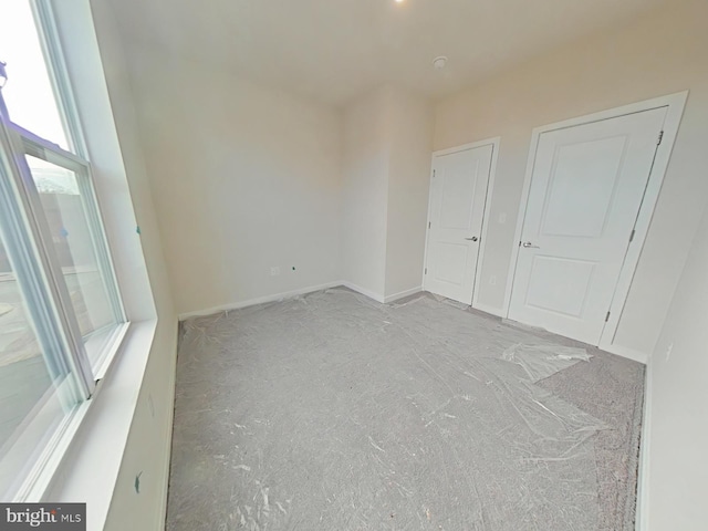 unfurnished room featuring light carpet