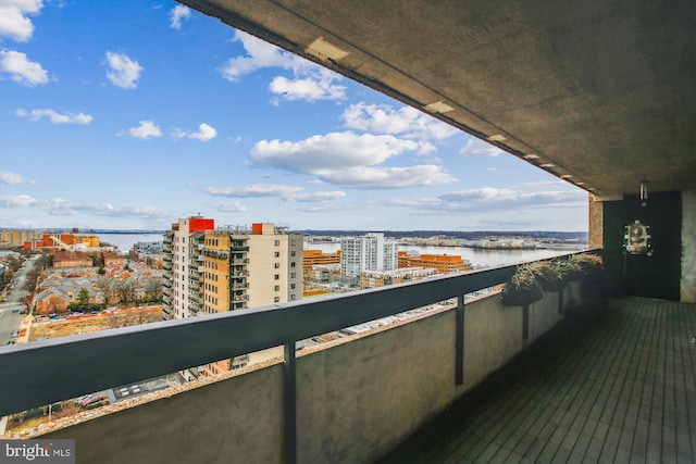 balcony featuring a view of city and a water view