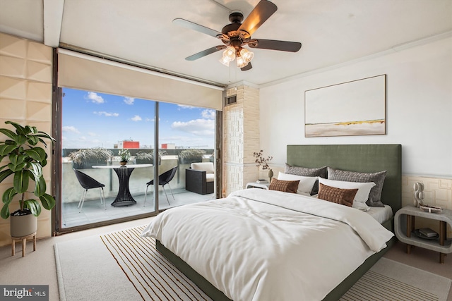 bedroom with ceiling fan, expansive windows, and ornamental molding