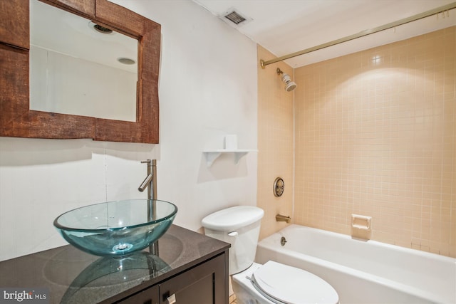 bathroom featuring  shower combination, visible vents, toilet, and vanity